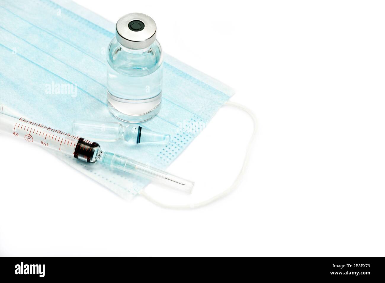 Mask, syringe, ampule and medication vial isolated on white background. Stock Photo
