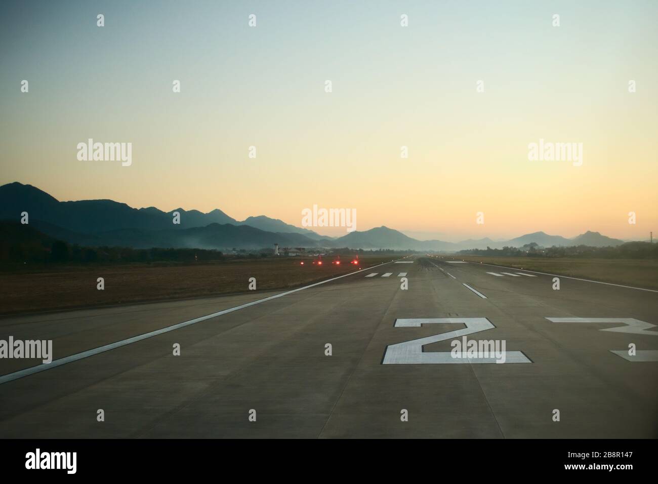 Airport runway at dawn. Travel, air transport, aeronautical industry concept. Stock Photo