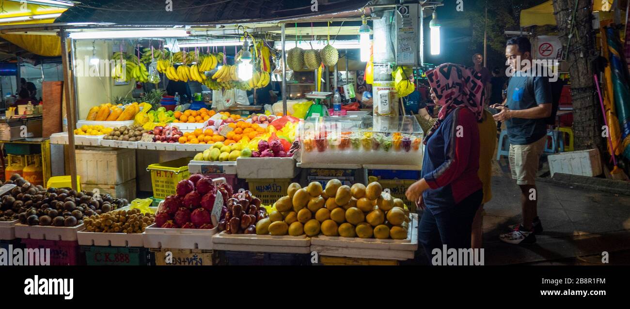 Vendor at a fresh fruit foodstall at Jalan Alor night markets Bukit