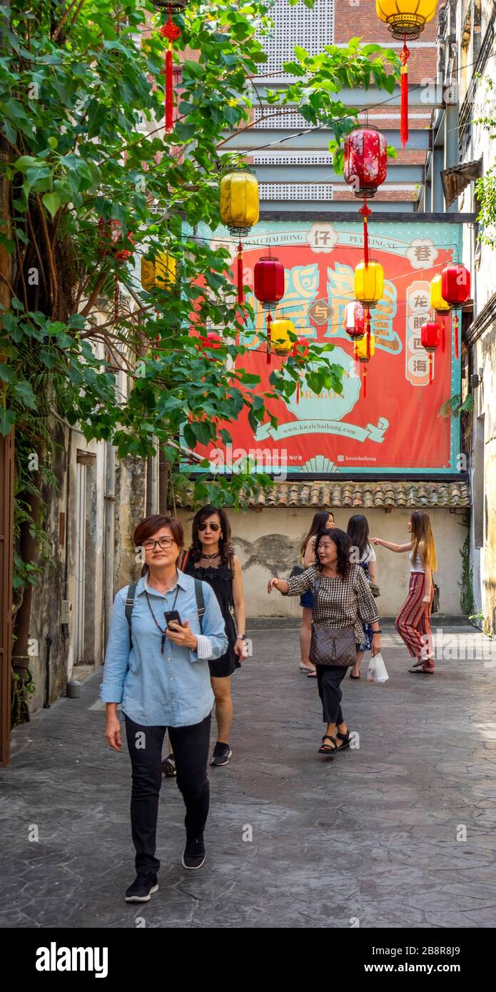 Tourists visiting Kwai Chai Hong laneway Lorong Panggung Chinese lanterns mural and street art Chinatown City Centre Kuala Lumpur Maylasia. Stock Photo