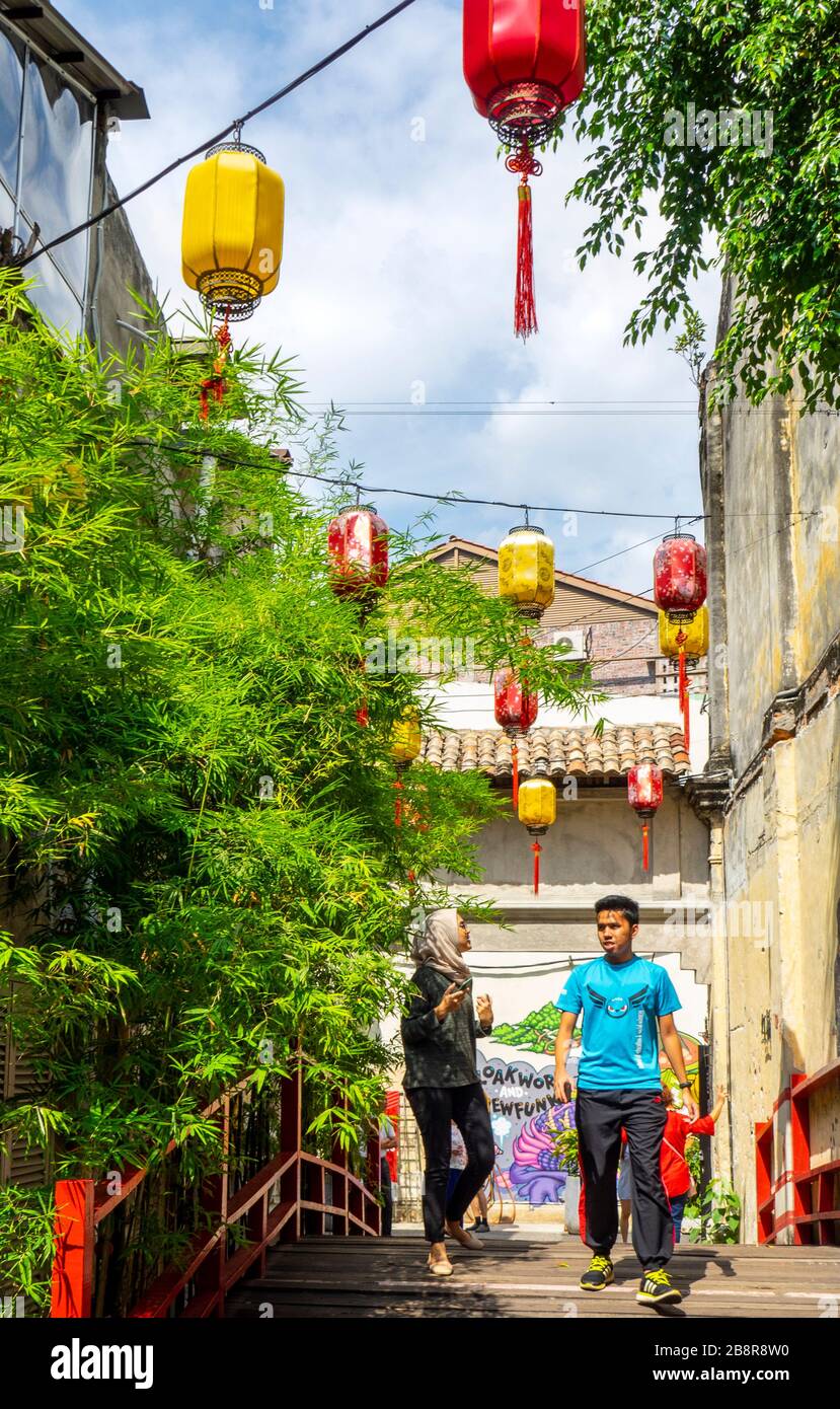 Tourists on Red Bridge entrance to Kwai Chai Hong laneway Lorong Panggung Chinese lanterns Chinatown City Centre Kuala Lumpur Maylasia. Stock Photo
