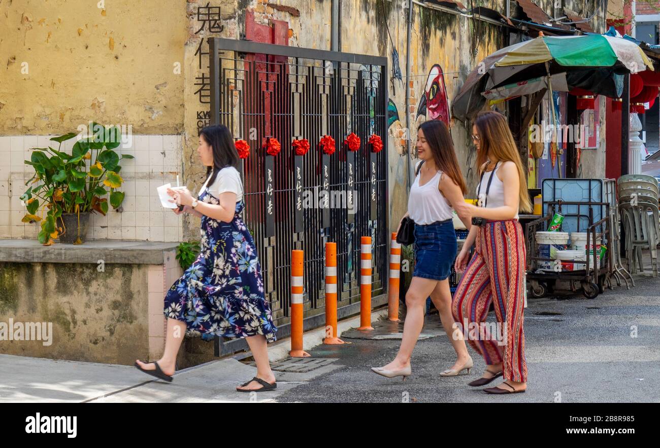 Asian female tourists walking along Lorong Panggung laneway Chinatown City Centre Kuala Lumpur Malaysia. Stock Photo