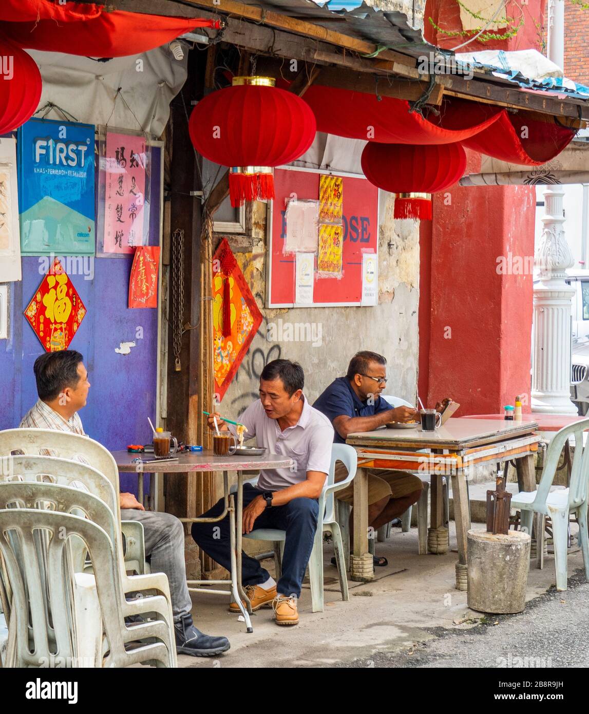 Diners sitting at alfresco outdoor dining in laneway Lorong Panggung