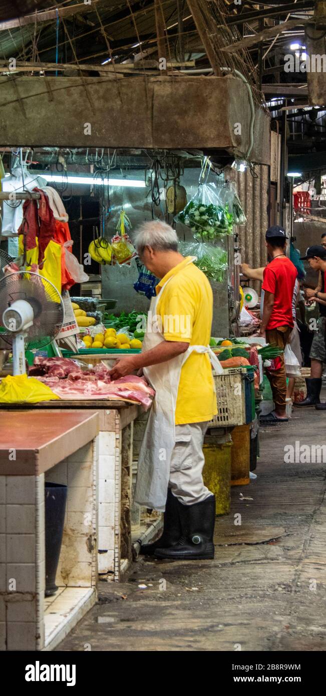 Butcher in wet market Petaling Street Markets Chinatown Kuala Lumpur Malaysia. Stock Photo