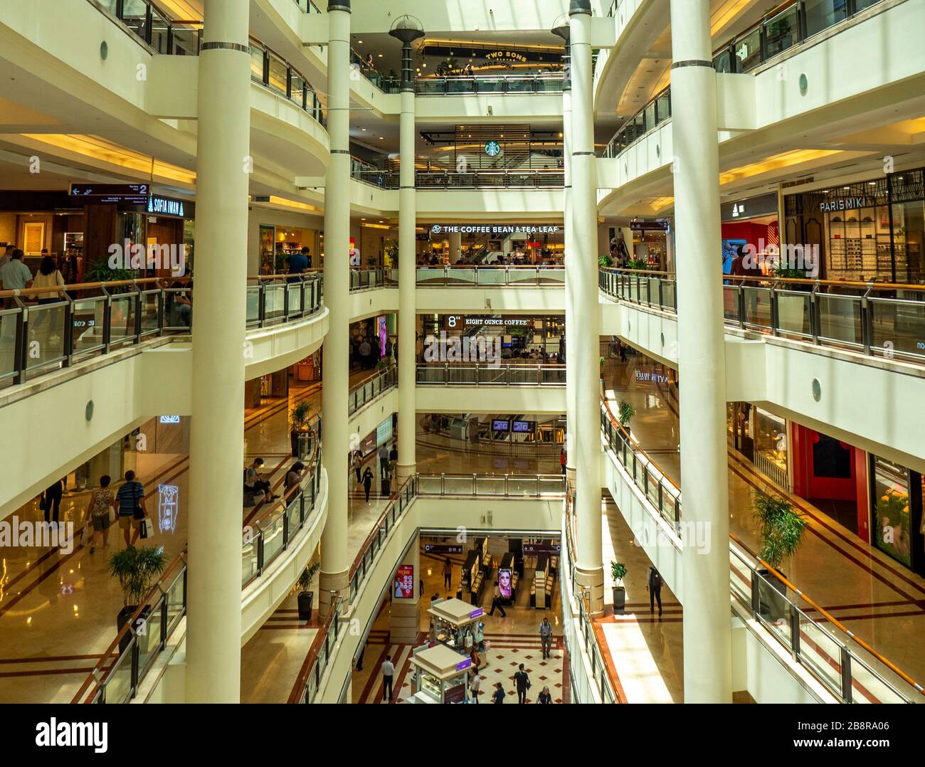 Cavernous atrium in multilevel Suria KLCC shopping mall at the base of the Petronas Twin Towers Kuala Lumpur Malaysia. Stock Photo