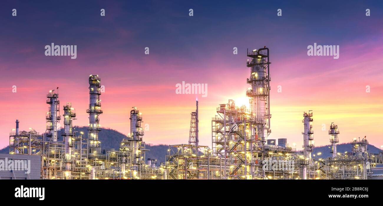 Panorama view of petrochemical oil and gas refinery and pipeline industry with sunset sky background Stock Photo