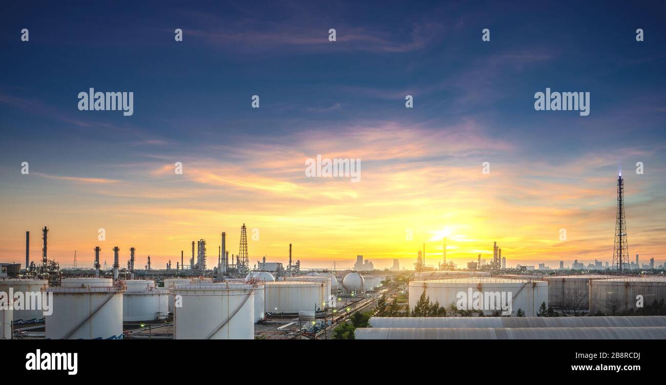 Panorama view of petrochemical oil and gas refinery and pipeline industry with sunset sky background Stock Photo
