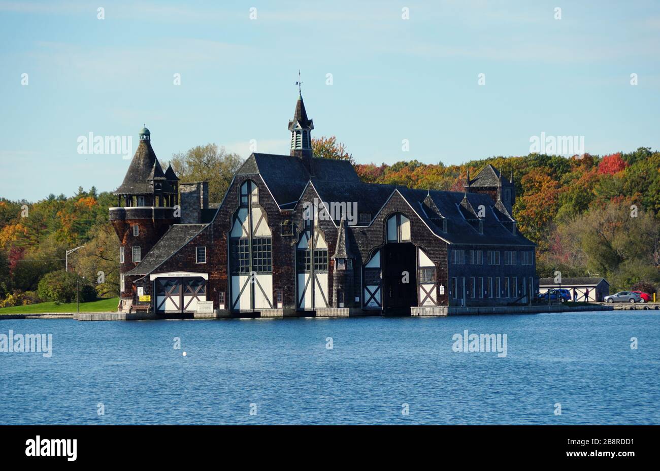 Alexandria Bay, New York, U.S.A - October 24, 2019 - The view of Boldt Yacht House overlooking striking fall foliage along St Lawrence River Stock Photo