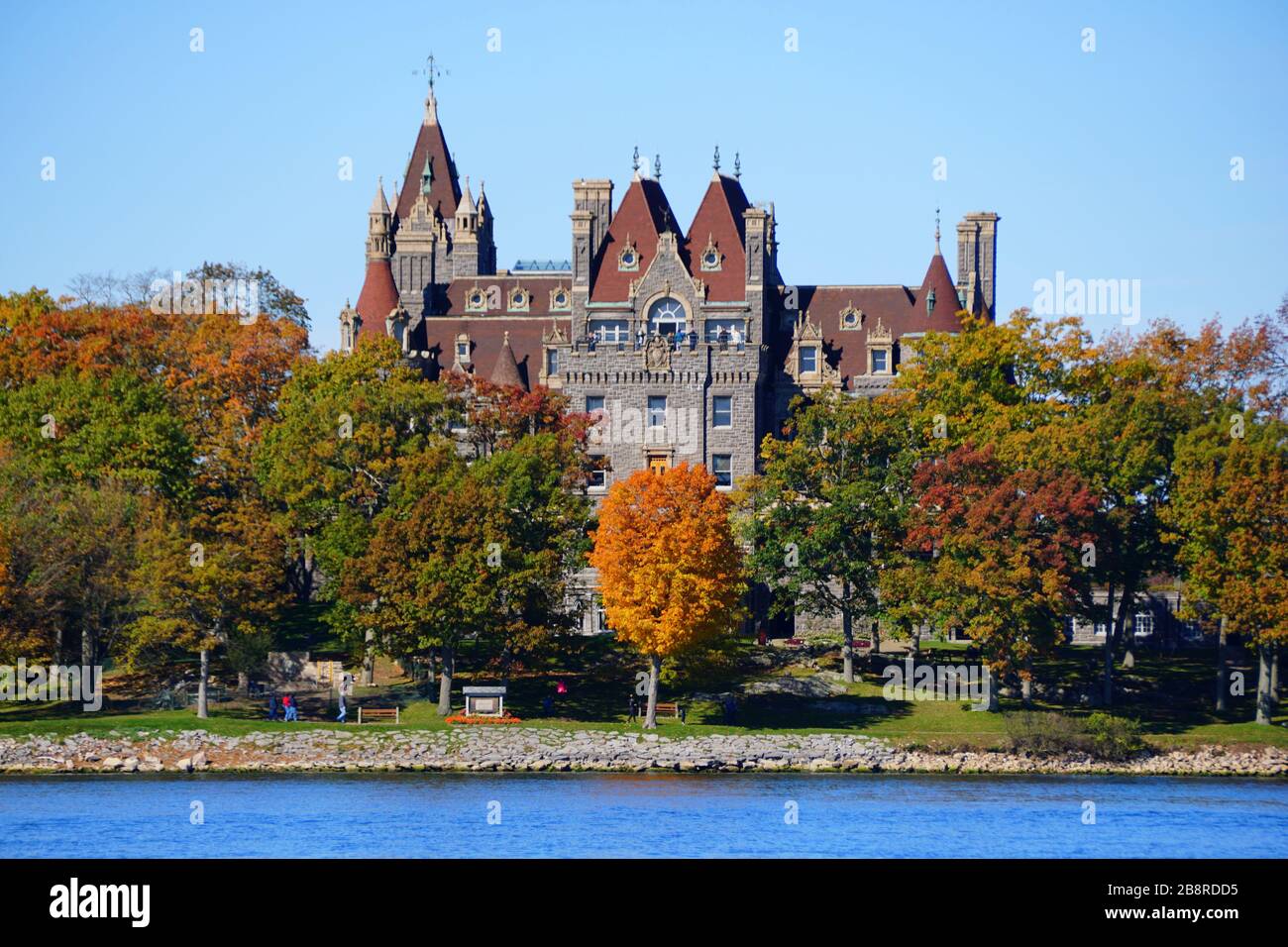 Alexandria Bay, New York, U.S.A - October 24, 2019 - The view of Boldt Castle surrounded by striking fall foliage along St Lawrence River Stock Photo