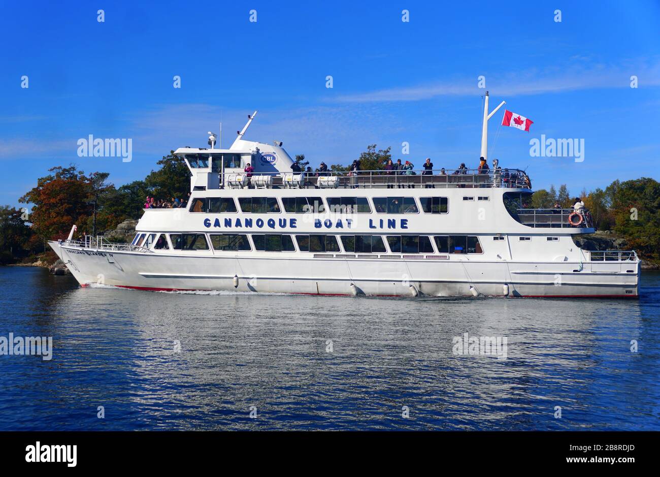 Alexandria Bay, New York, U.S.A - October 24, 2019 - The Gananoque Boat Line with passengers passing by St Lawrence River and Thousands Islands Stock Photo