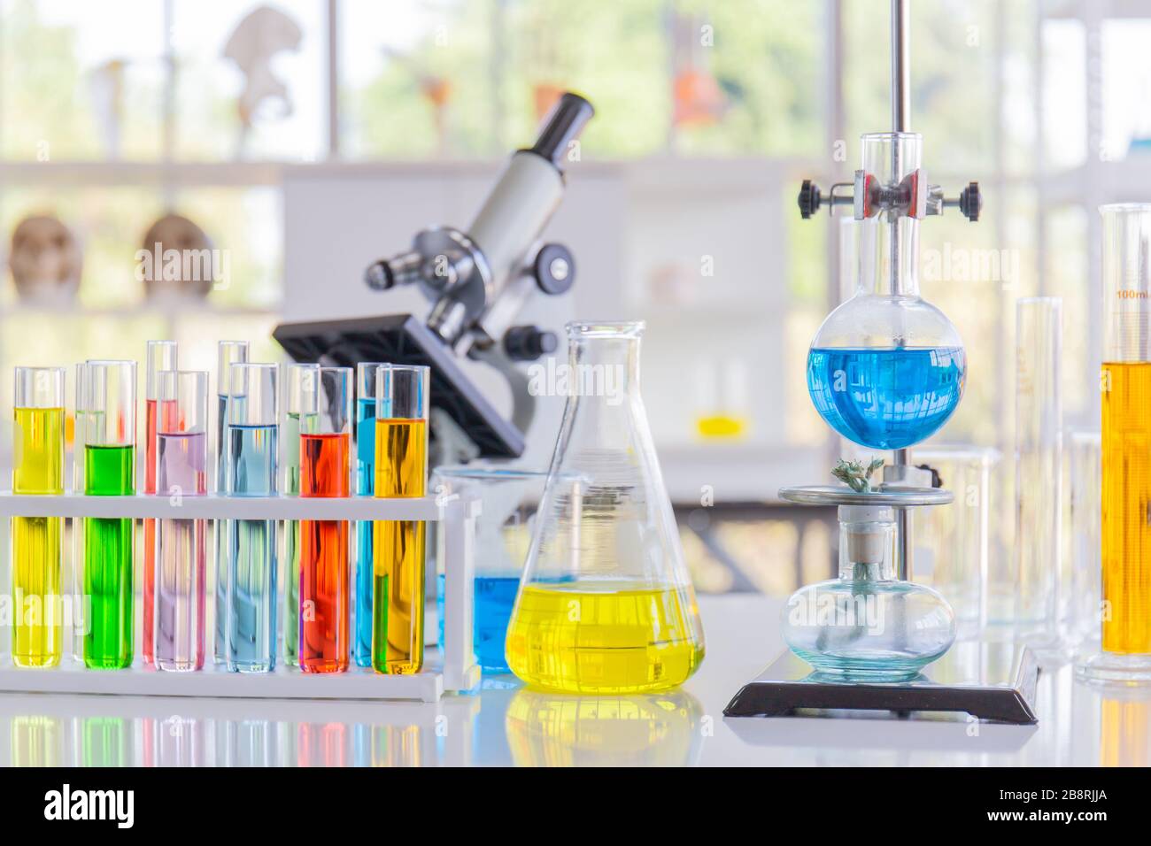 Chemical reagents in glass bottles of various shapes, scientific experiments of various sizes. Stock Photo