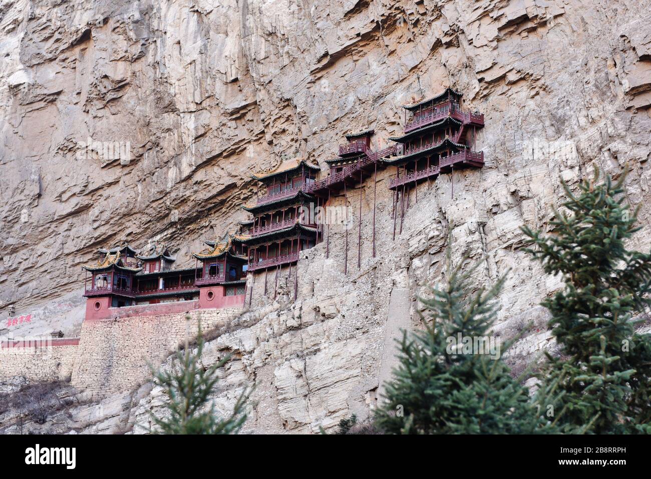 Datong, DaTong, China. 23rd Mar, 2020. Shanxiï¼ŒCHINA-Photo taken on March 22, 2020 shows the temple building in hunyuan county, datong city, north China's Shanxi Province.Xuankong temple, located in hunyuan county, datong city, Shanxi Province, ''north mountain'' hengshan jinlong gorge between the west side of the cuiping peak cliff, known as hengshan 18 ''the first scenic spot.'' Originally named ''xuankong pavilion'', ''xuan'' was taken from the teachings of Chinese Taoism, ''kong'' was taken from the teachings of Buddhism, later renamed ''xuankong temple'', because the whole temple is Stock Photo