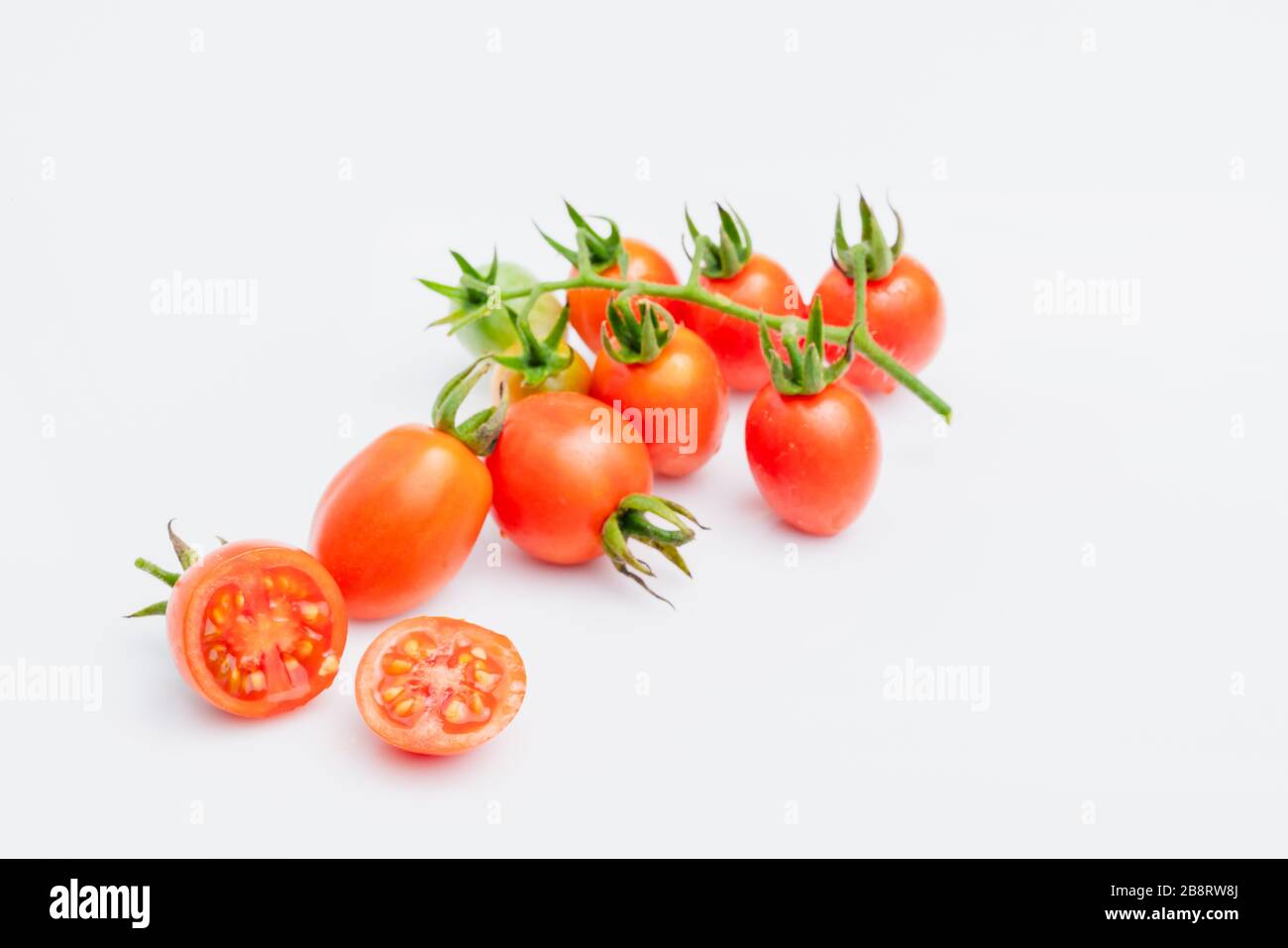 fresh red cherry tomatoes (grape tomatoes ) on white background. Stock Photo