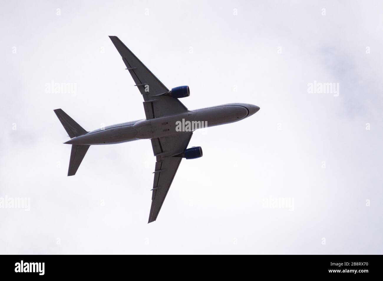 Low angle view of Commercial airplane in mid flight; Stock Photo