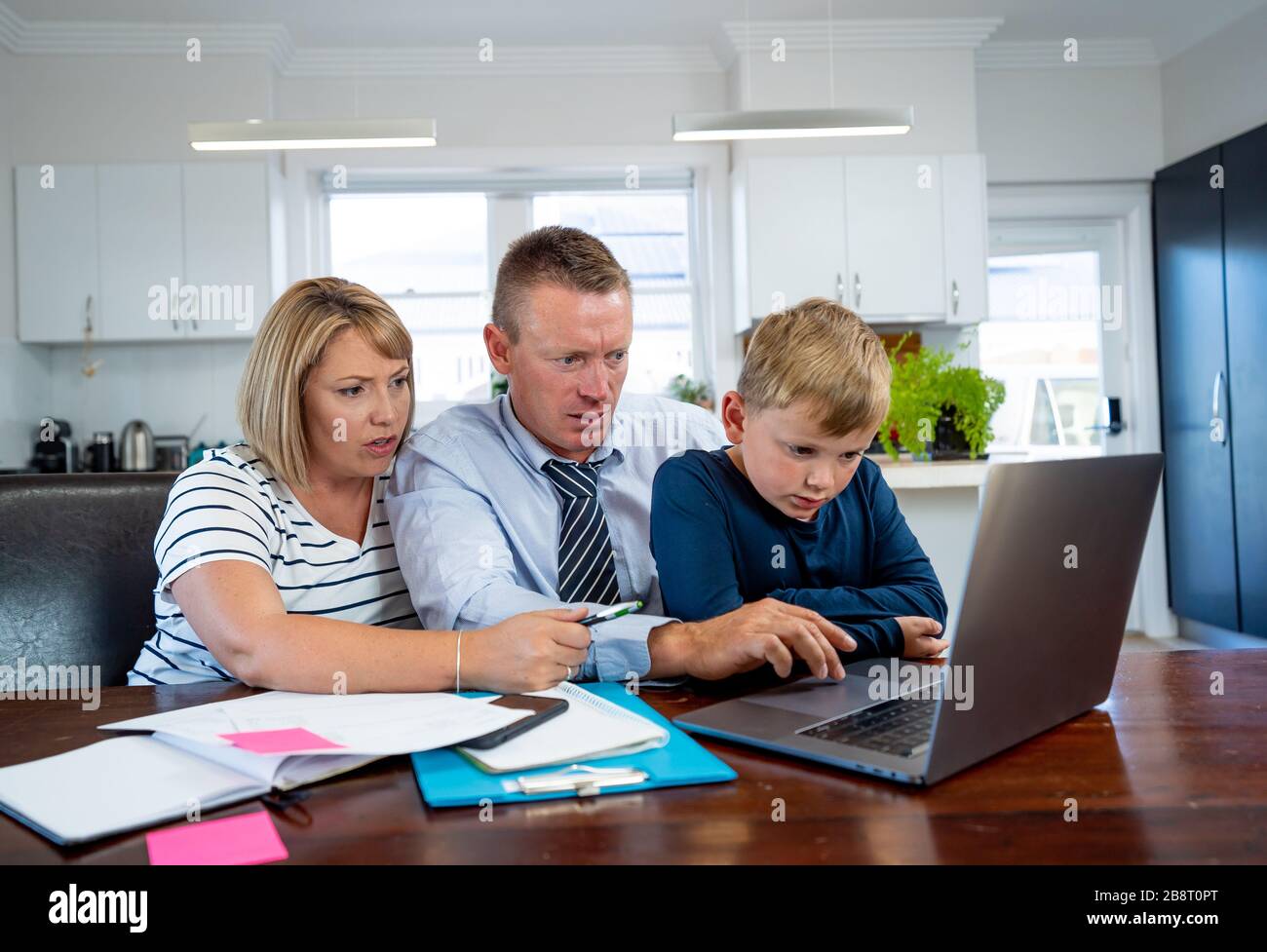 Coronavirus outbreak. Family in quarantine, kids fighting and parents in distress over home finances, job loss, school shutdowns and small business de Stock Photo