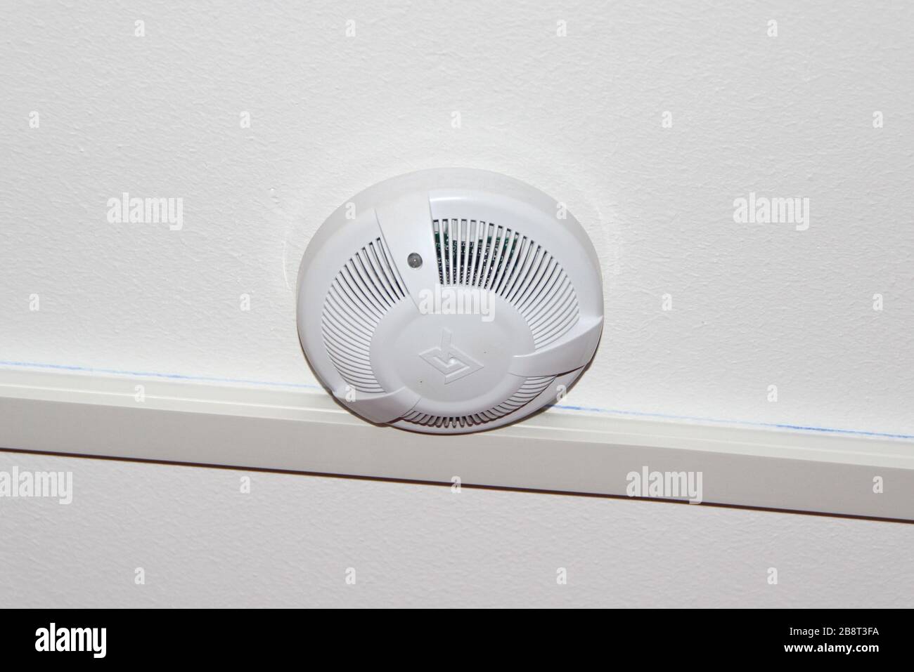 White smoke detector on the ceiling. Fire safety and alarm concept ...