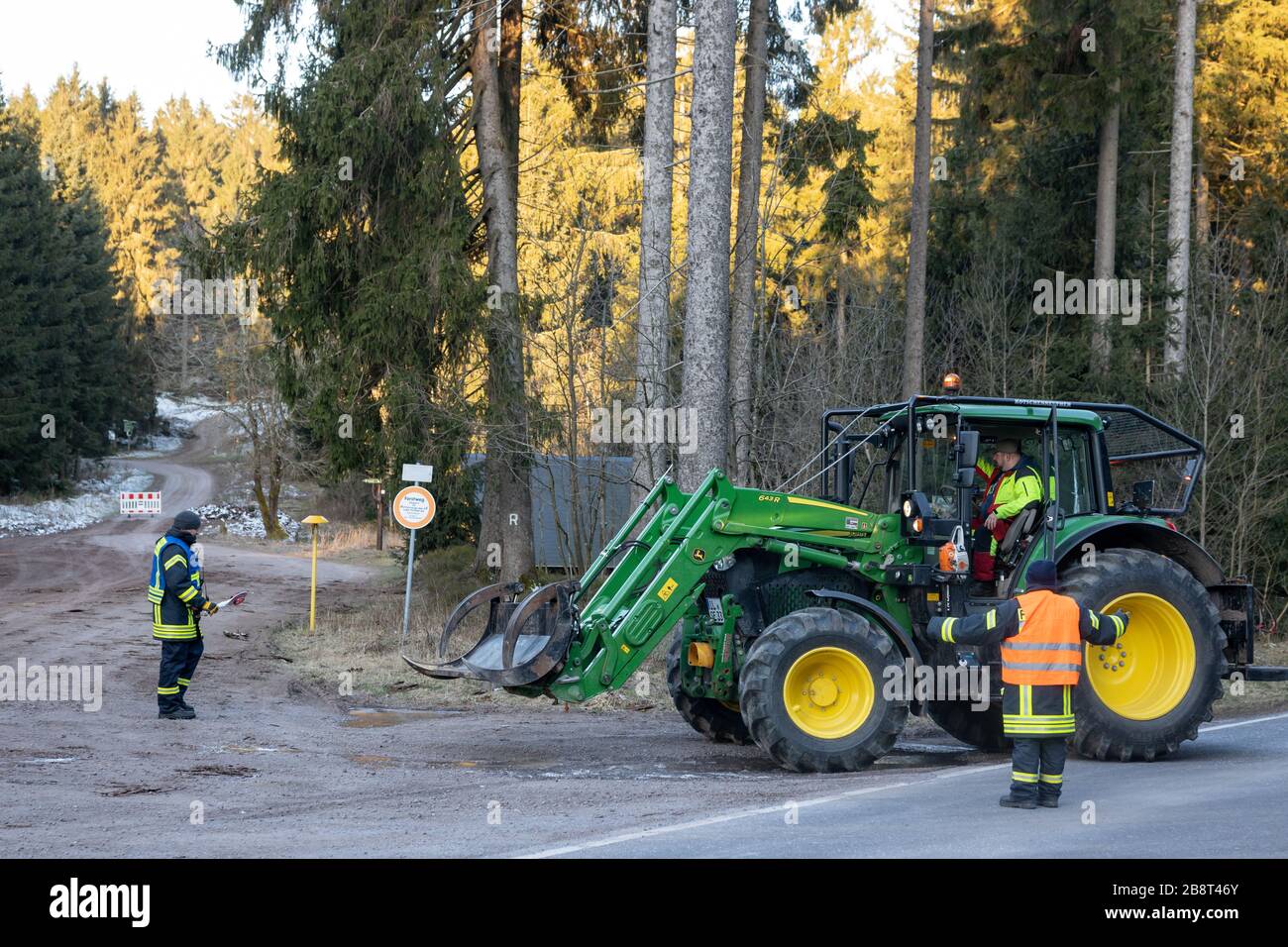 Neustadt Am Rennsteig, Germany. 23rd Mar, 2020. Firefighters block the road and forest paths one kilometre before Neustadt am Rennsteig. After six of the eleven cases of Covid-19 in the Ilm district came from the village in the rural community of Großbreitenbach, the village was completely quarantined for two weeks. Credit: Michael Reichel/dpa-Zentralbild/dpa/Alamy Live News Stock Photo