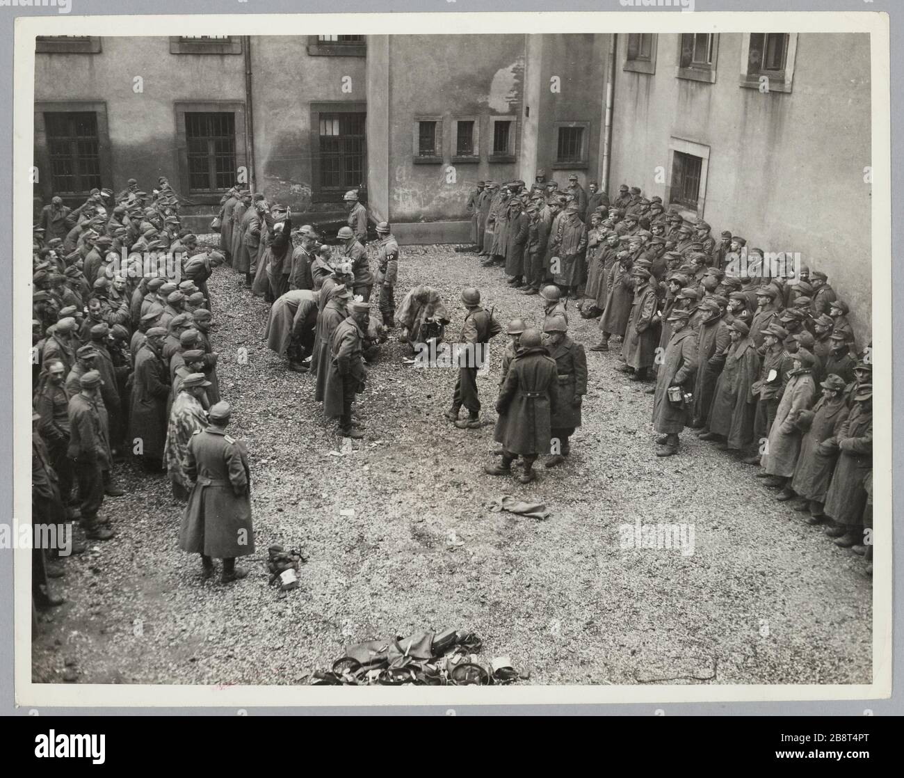 Searches of German prisoners by US military police in a military district court (44th Div.) (?); 11/22/1944 Stock Photo