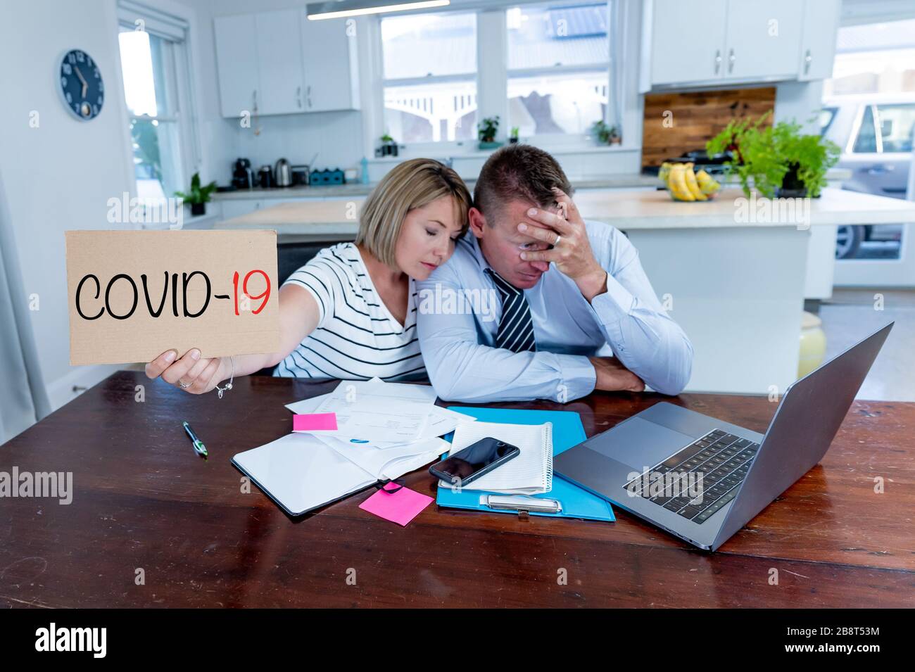 Coronavirus economic recession. Family couple in distress of job losses worried about bills, credit debts, loans and home finances. Impact of COVID-19 Stock Photo