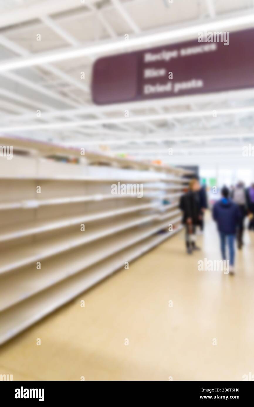 Blurred interior background image of empty supermarket shelves due to Covid-19, Coronavirus, induced stockpiling Stock Photo