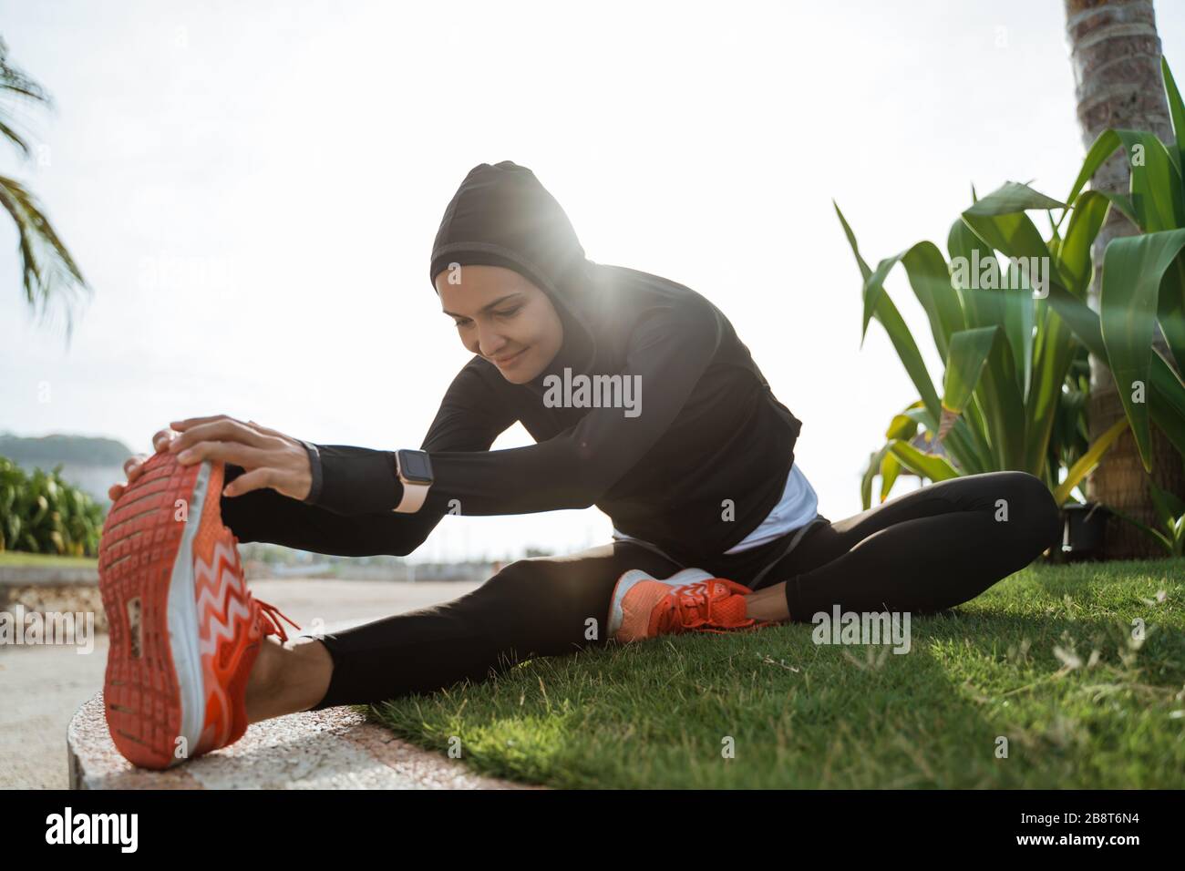 woman with muslim sport wear stretching. sporty female using head scarf