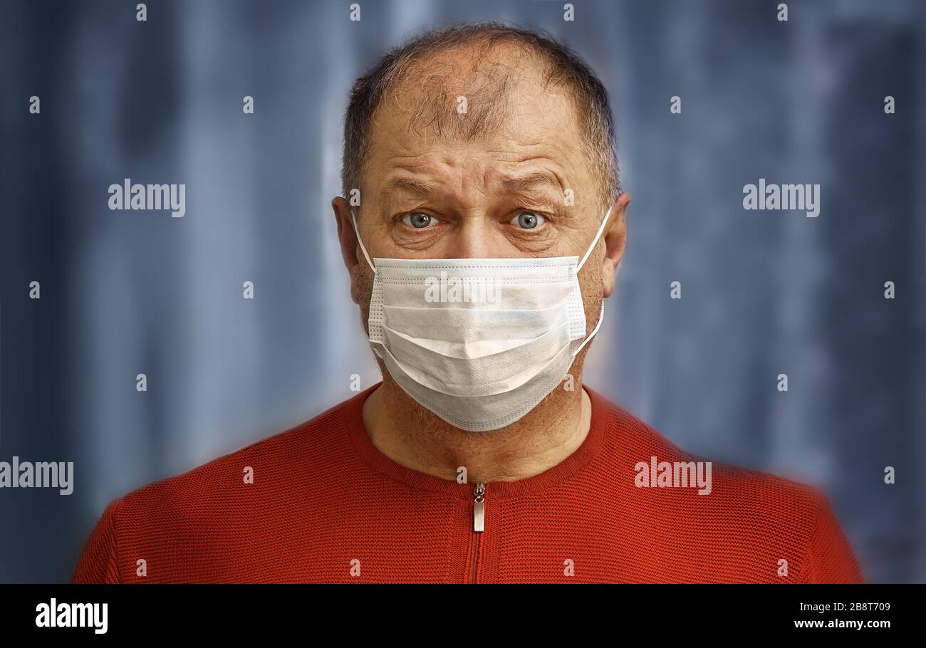 The man in a gauze mask with frightened eyes, the concept of human fear