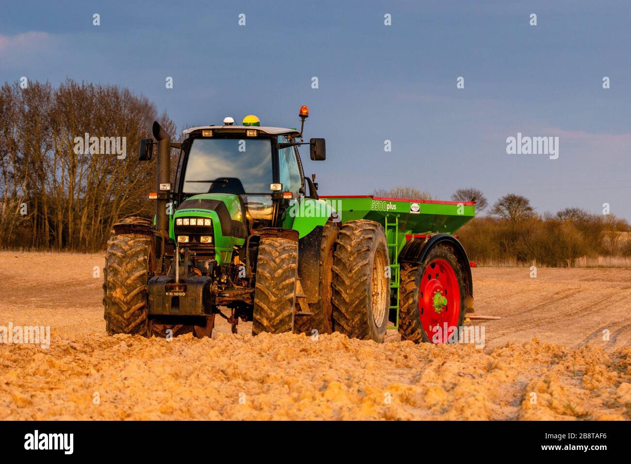 Szczecin,Polska-March 2020:DEUTZ-FAHR agricultural tractor in the spring field during fertilizing with fertilizer Stock Photo
