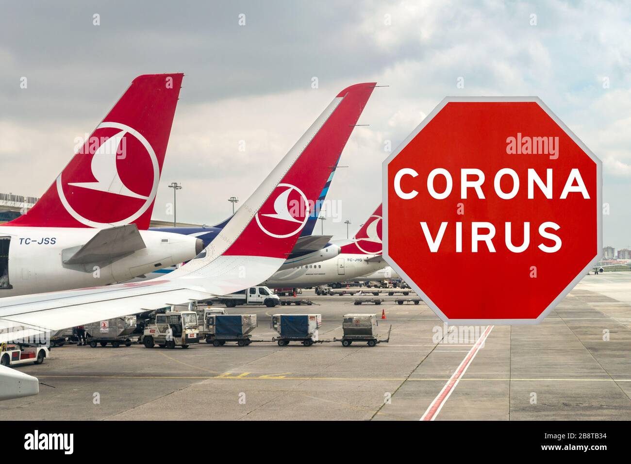 composite showing corona virus warning sign in front of Turkish Airlines aircraft at Istanbul airport, travel restriction concept Istanbul Ataturk Air Stock Photo