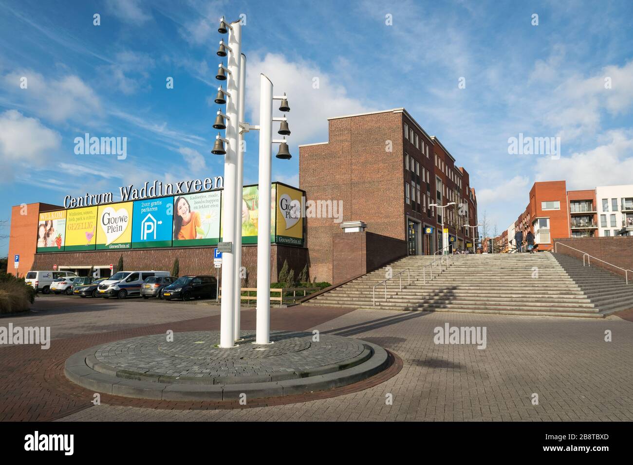 Entrance of modern centre of the town of Waddinxveen in Holland. Traditional chimes or carillon in the foreground. Stock Photo