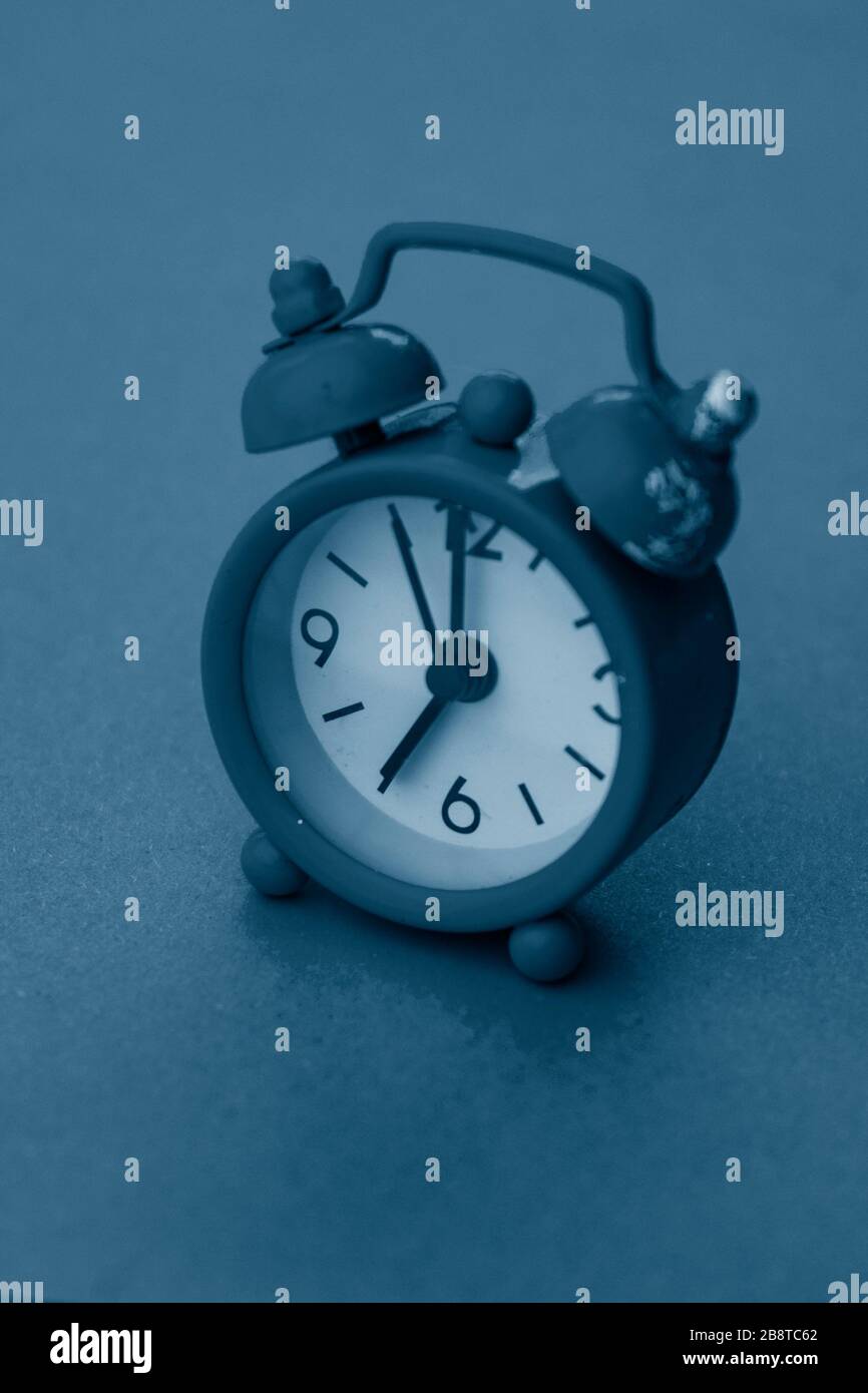 selective focus, small blue alarm clock with numbers Stock Photo Alamy