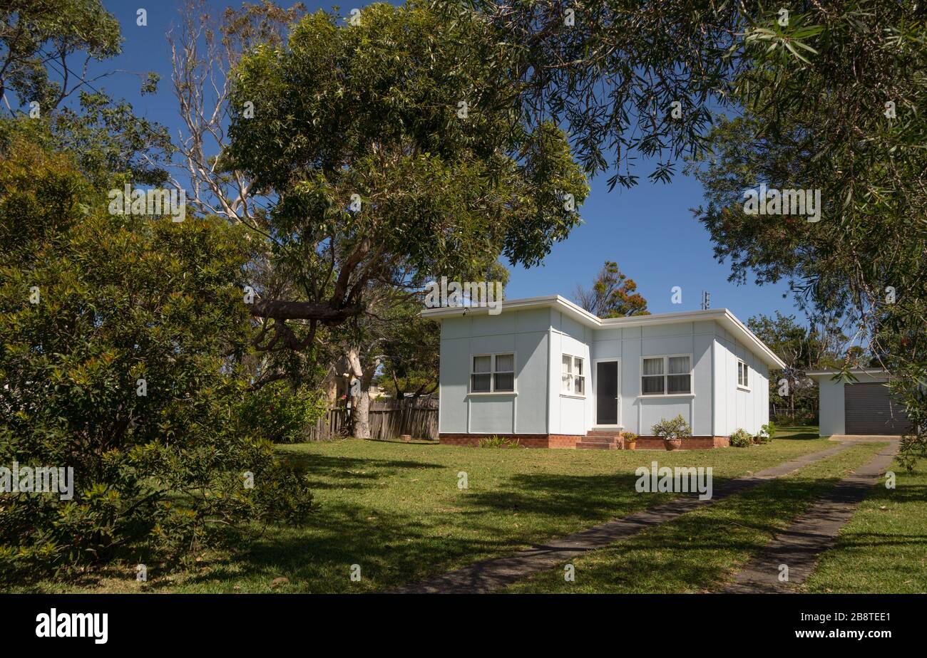 A typical 'fibro' holiday house on a plot of land South Coast New South Wales Stock Photo