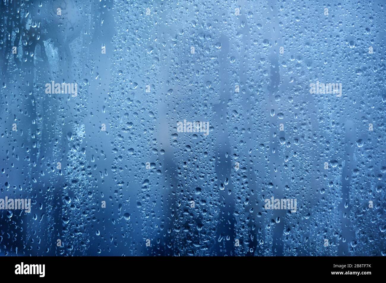 Rainy background, rain water drops on the window or in shower stall, autumn season backdrop, abstract textured wallpaper Stock Photo