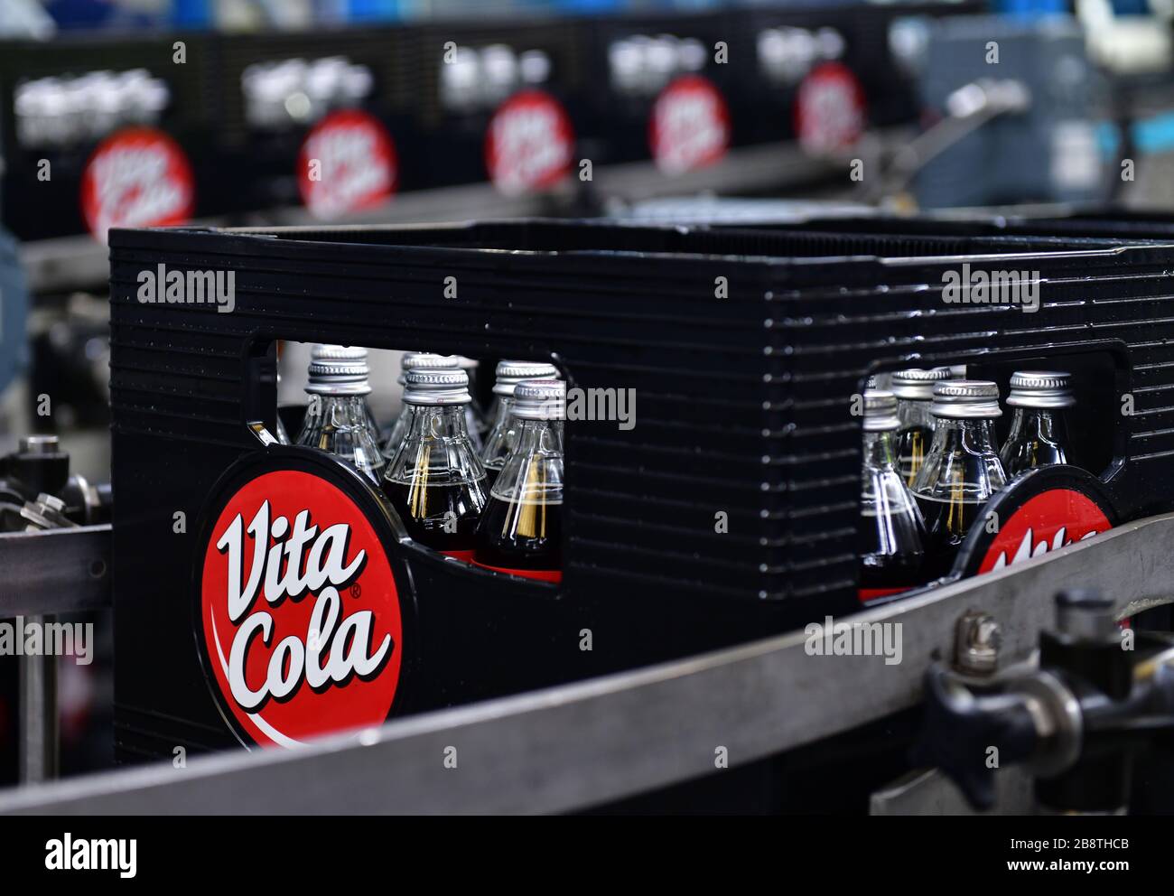 Lichtenau, Germany. 19th Mar, 2020. After filling Vita Cola, the 0.33 litre returnable glass bottles are transported in crates on the conveyor system. Vita Cola is owned by Thüringer Waldquell GmbH in Schmalkalden, which is part of the Hassia Group in Hesse. Credit: Martin Schutt/dpa-Zentralbild/dpa/Alamy Live News Stock Photo