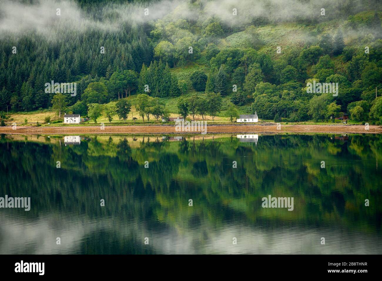 A beautiful loch with mist, and reflections at Glenelg Scotland. Stock Photo