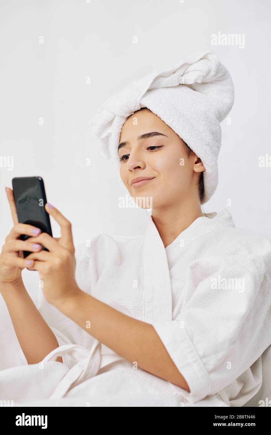 Beautiful young woman in bath robe and towel on her head taking selfie  after shower Stock Photo - Alamy, image size:866x1390