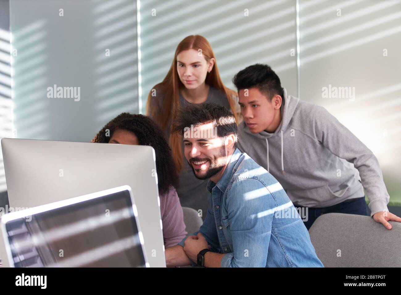 Creative web designer start-up team works together on the computer Stock Photo