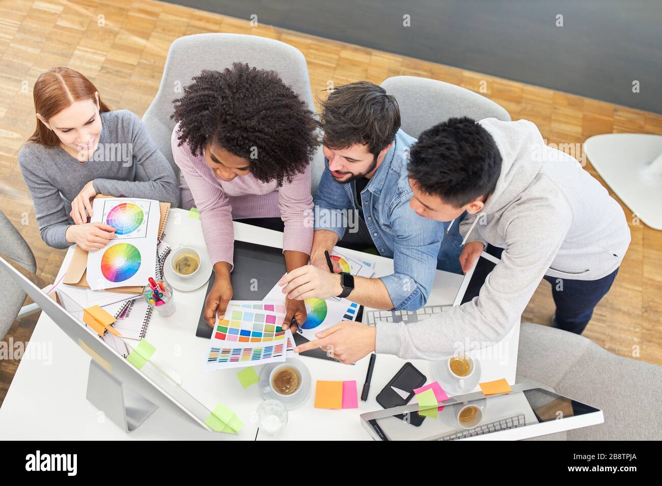 Start-up team brainstorming about color design in the office of a design agency Stock Photo
