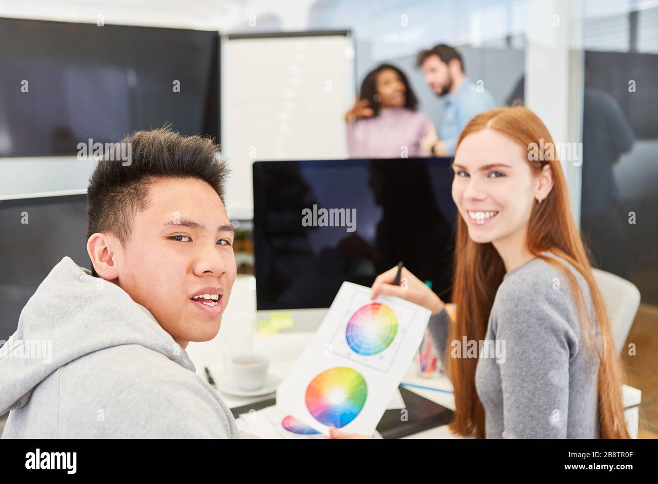 Graphic designer creative team in the office on the computer in the color design with color wheel Stock Photo