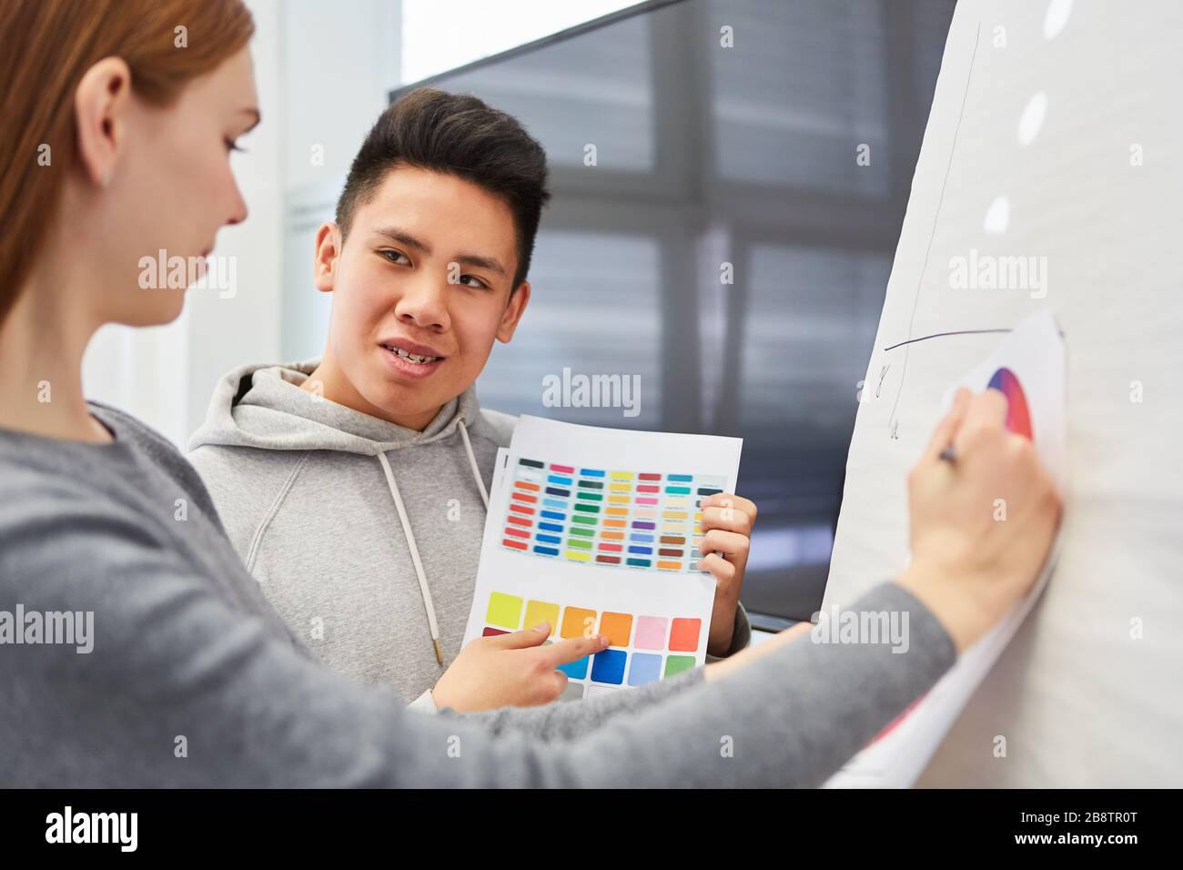 Asian graphic designer makes a suggestion for the color design of a website Stock Photo