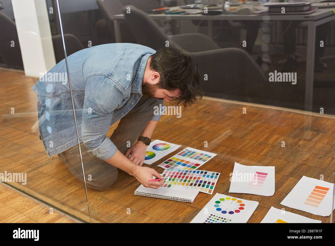 Graphic designer checking color samples for printing in a design agency Stock Photo