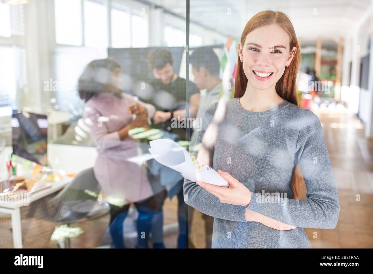 Smiling young woman as a trainee or trainee for feminism and equality Stock Photo