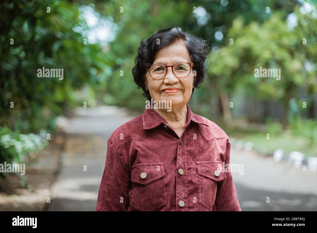 asian granny vids close up confident Asian grandma wearing eyes glasses stand in the park  Stock Photo - Alamy