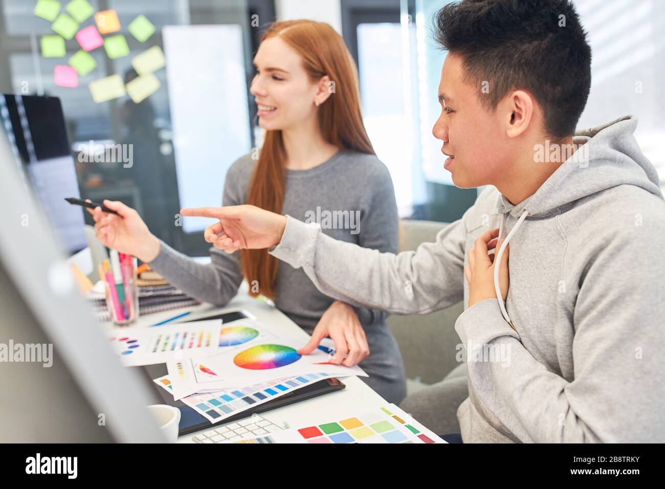 Two graphic designers or developers find a color design solution for a project Stock Photo