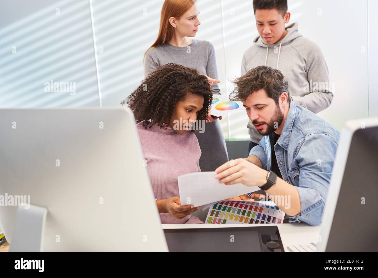Web developer and graphic designer when choosing the color design for a customer project Stock Photo
