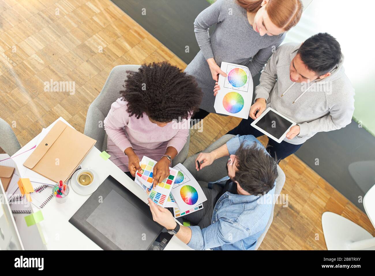 Graphic designer team in internet agency discusses color design of a website Stock Photo