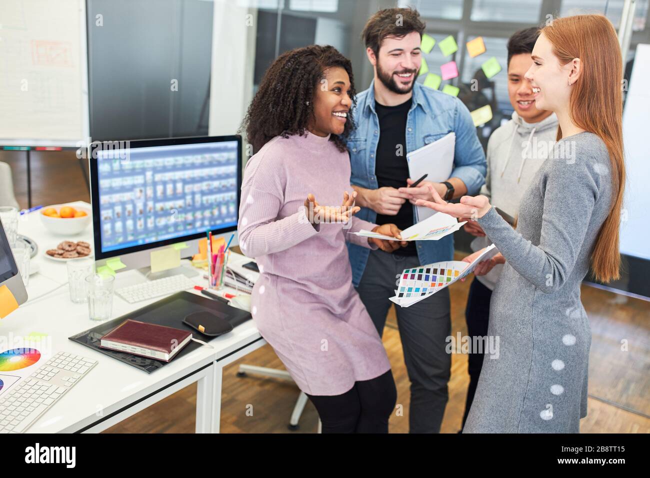 Web designers and web developers as a creative start-up team in a meeting Stock Photo