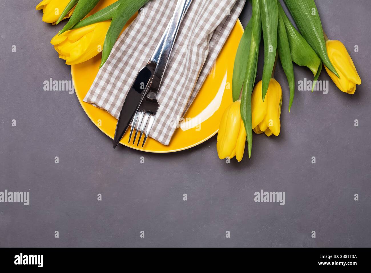 Festive table with yellow tulips. Stock Photo