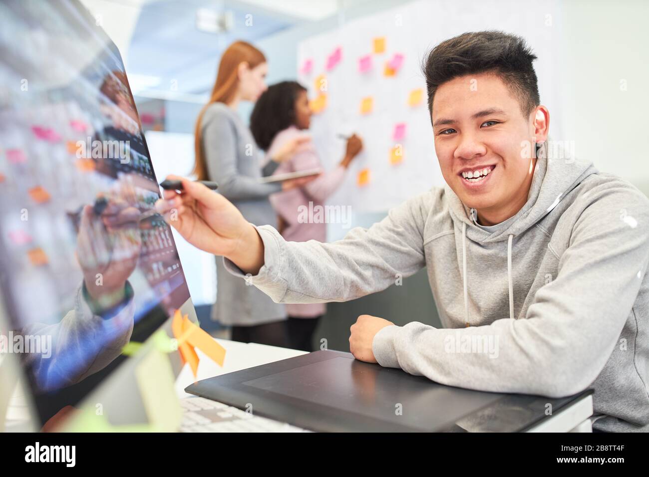 Creative graphic designer is happy about an idea for the layout of a website Stock Photo