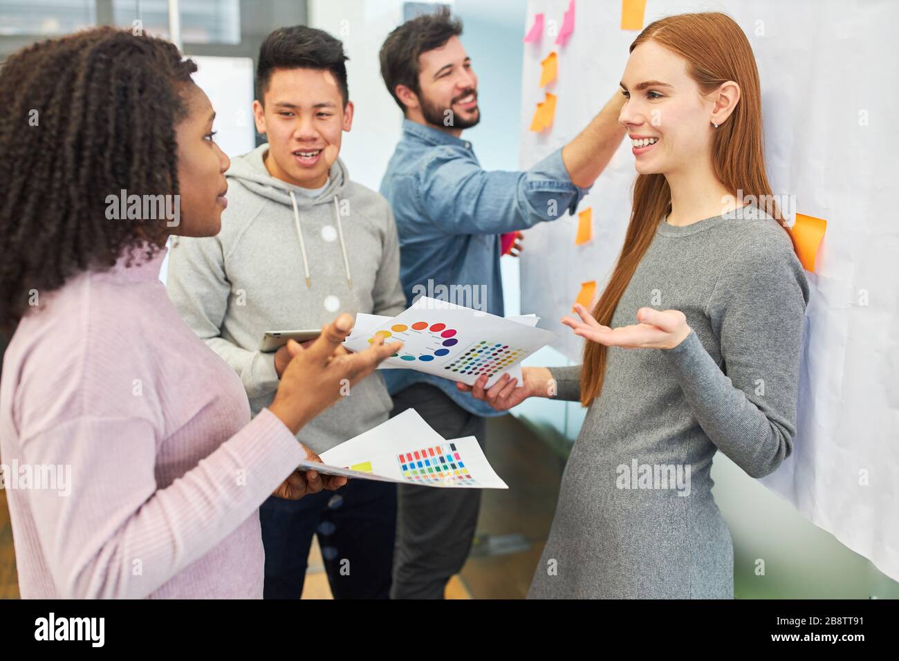 Creative team discusses color design for a project in a brainstorming meeting Stock Photo