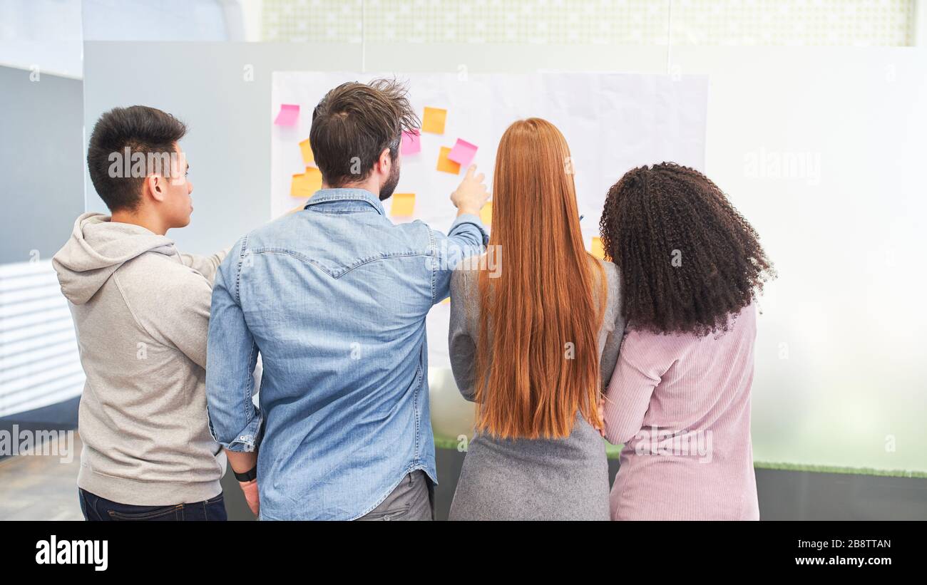 Web designers and developers as a team in the creative brainstorming workshop Stock Photo